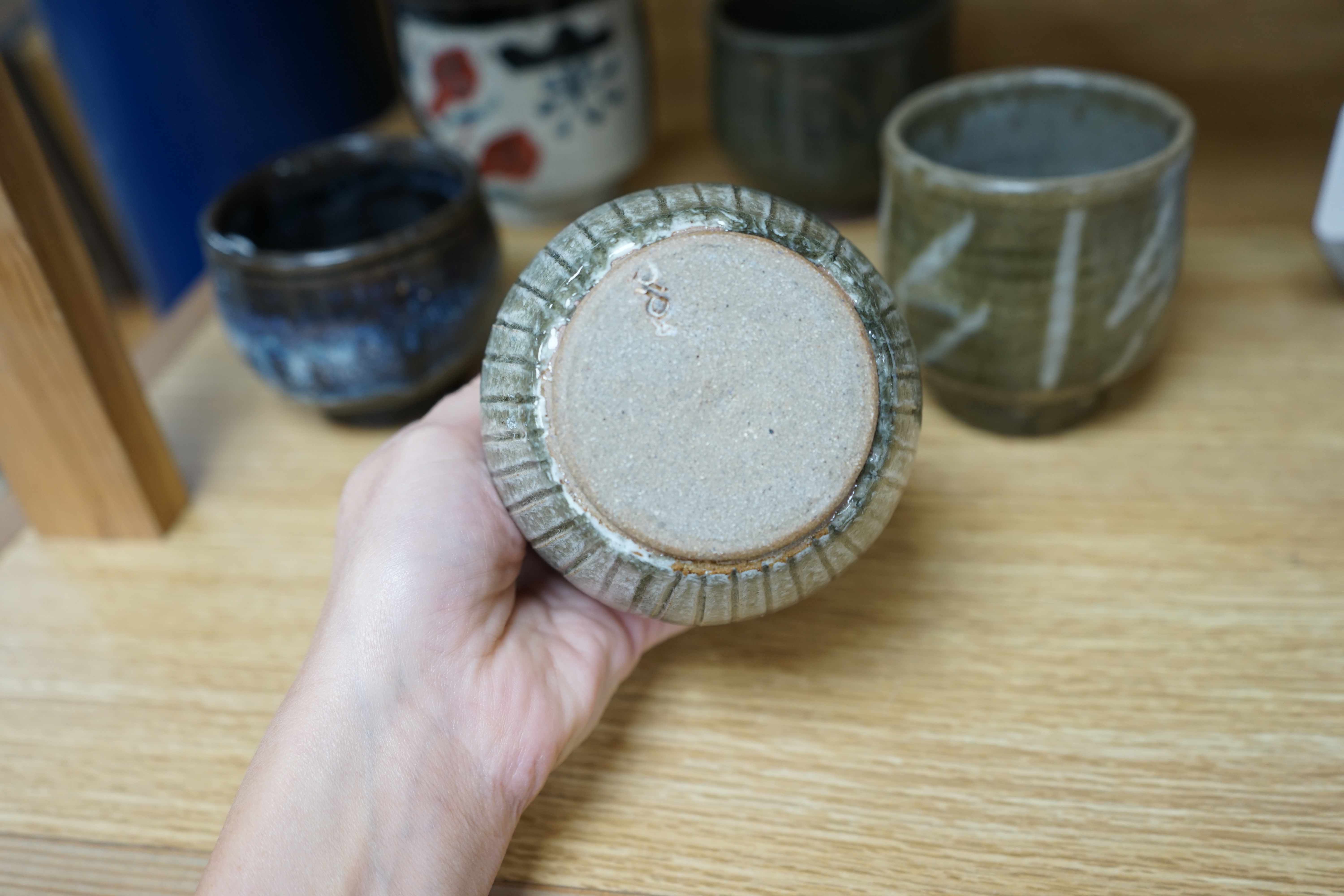 Five Japanese and European studio pottery yunomi, including an example by John Maltby, 10.5cm, together with another signed with a ‘P’ to the base. Condition - good.